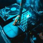 cropped view of dj woman using dj equipment in nightclub