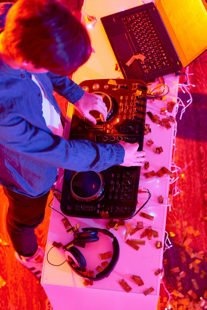 Young DJ playing music on modern party